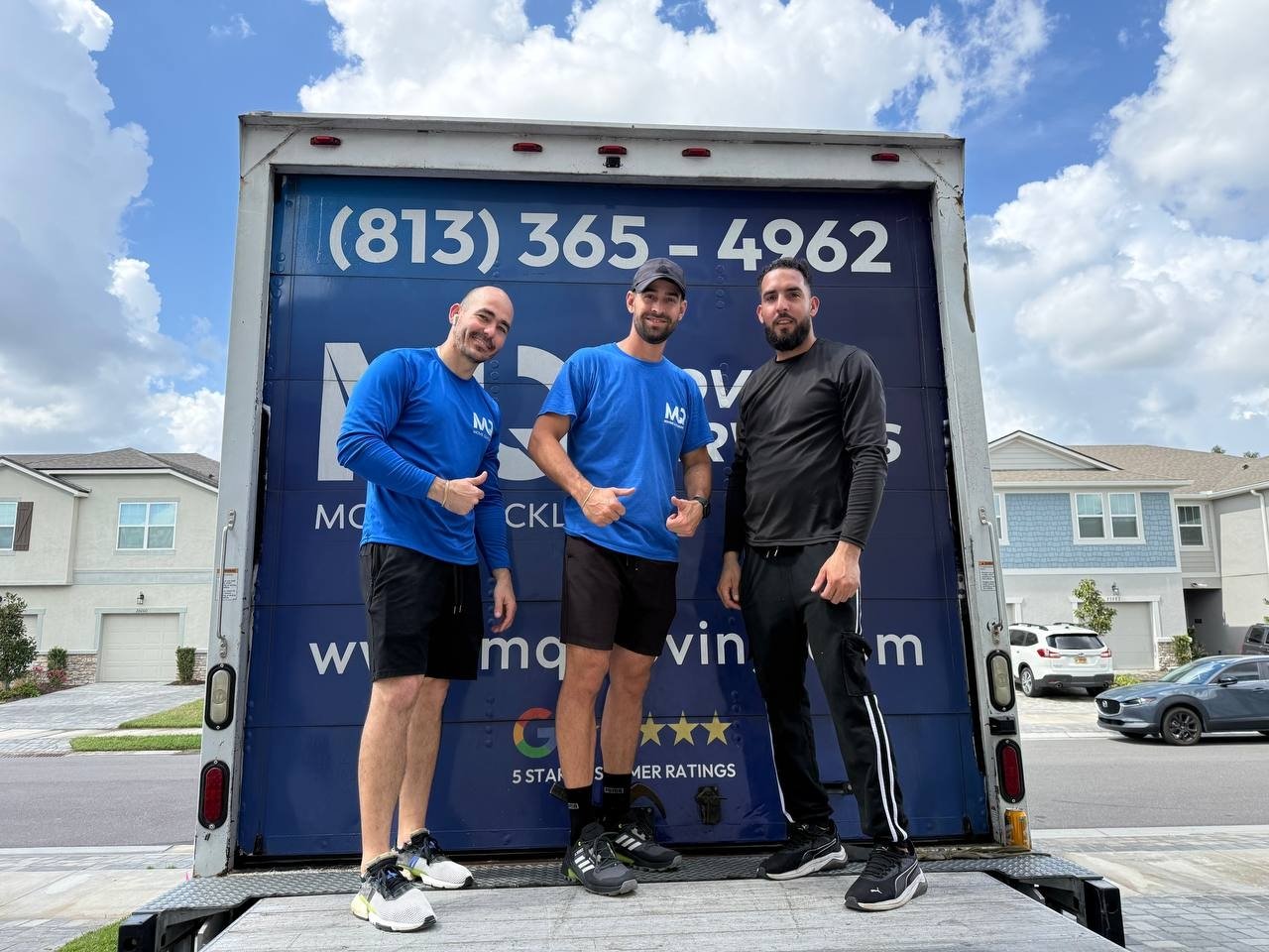 Three Move Quickly LLC team members at truck door showing Google 5-star ratings — Tampa Bay movers