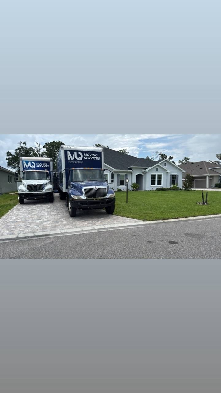 Move Quickly LLC branded trucks parked at a Tampa Bay Florida home — residential moving services